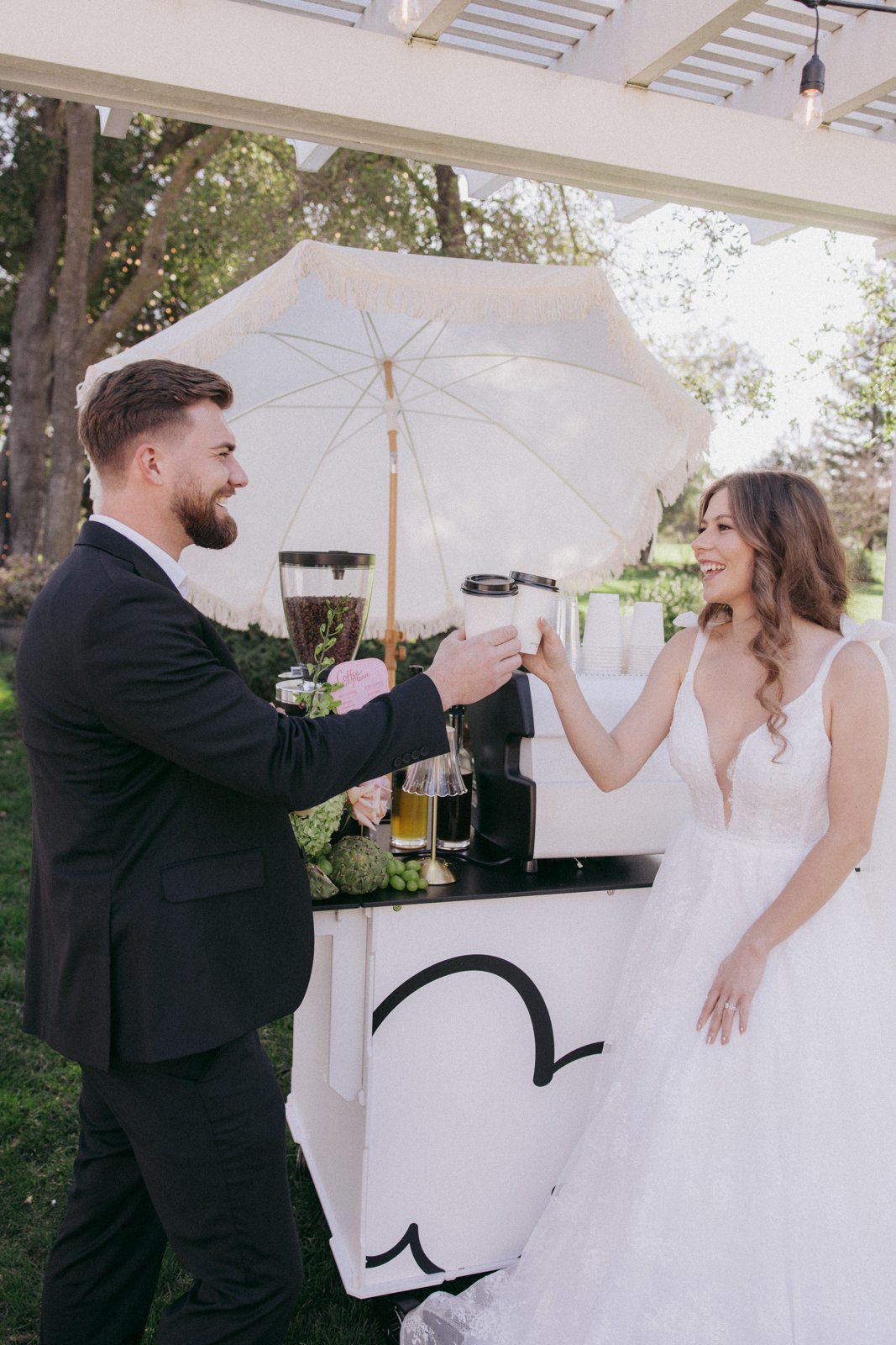 Bride and groom toasting with coffee at the Holy Coffee cart