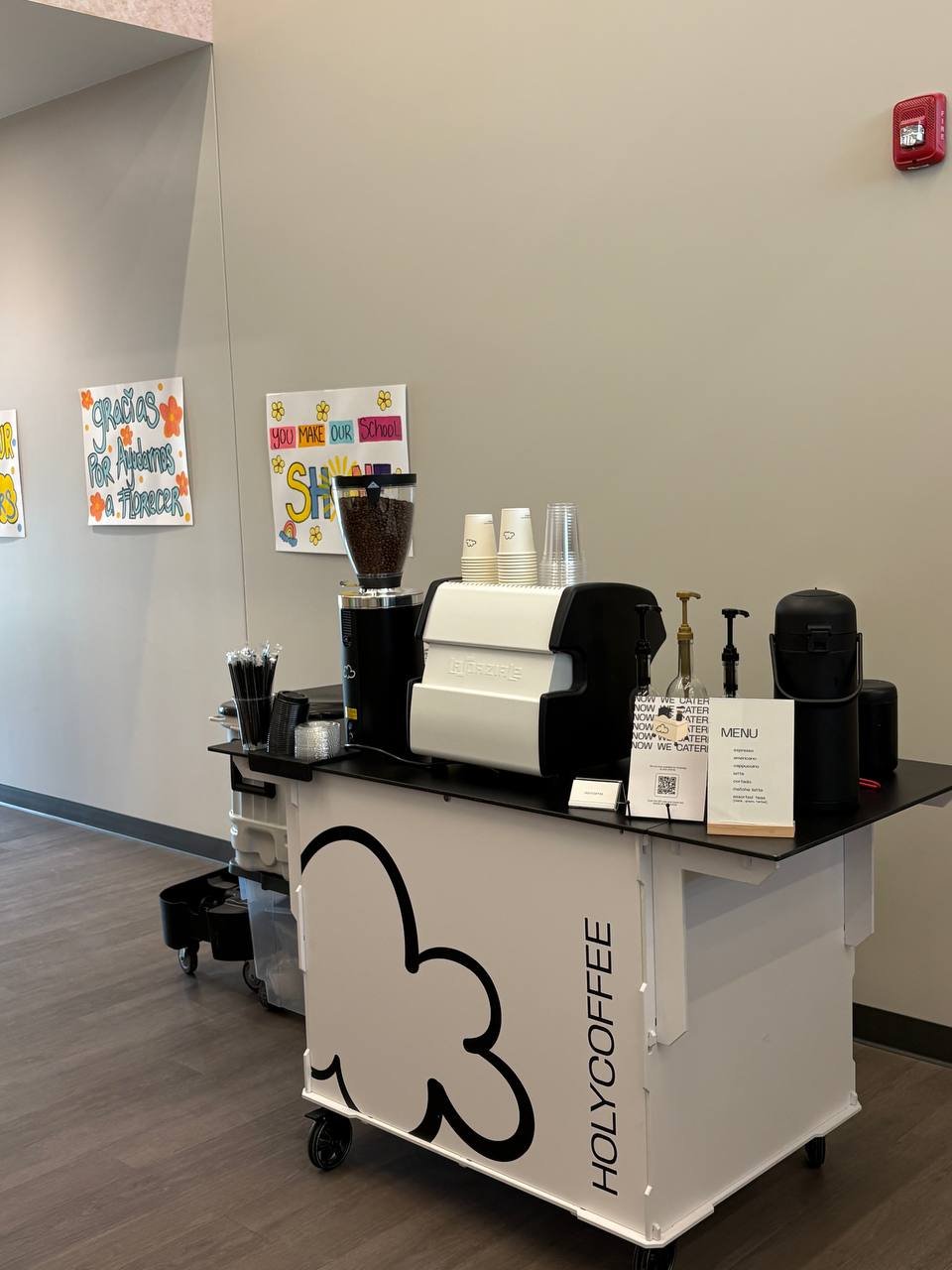 Holy Coffee cart set up in an office hallway