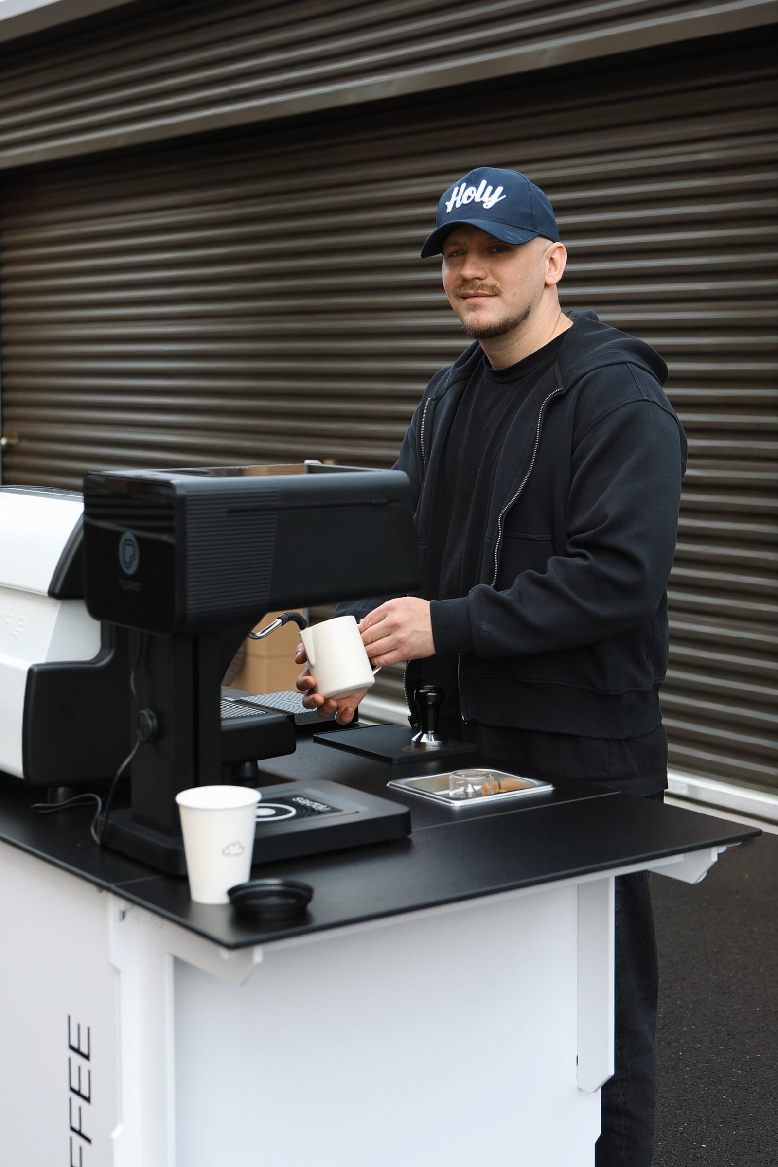 Barista in a Holy cap at the cart