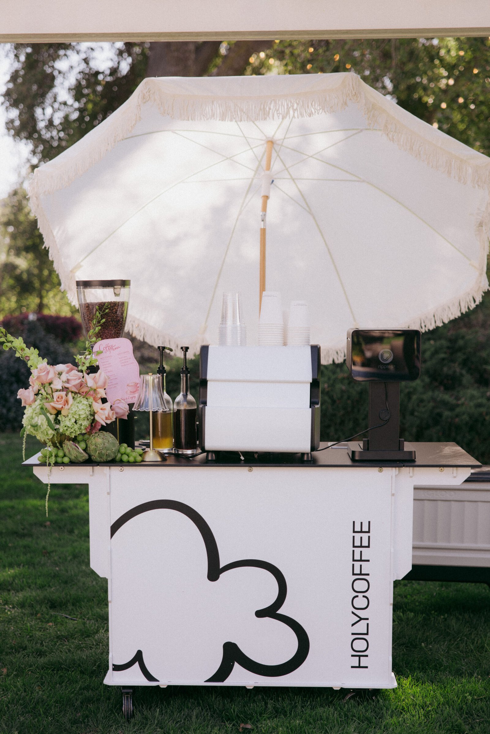Holy Coffee cart with flowers