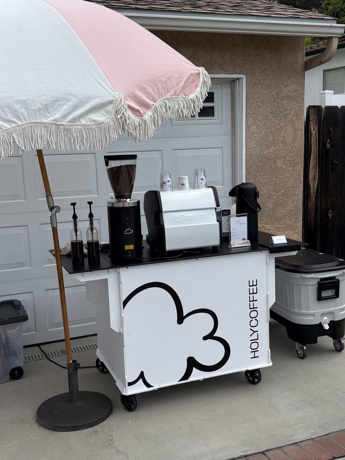 Holy Coffee cart with a pink fringed umbrella at a private party