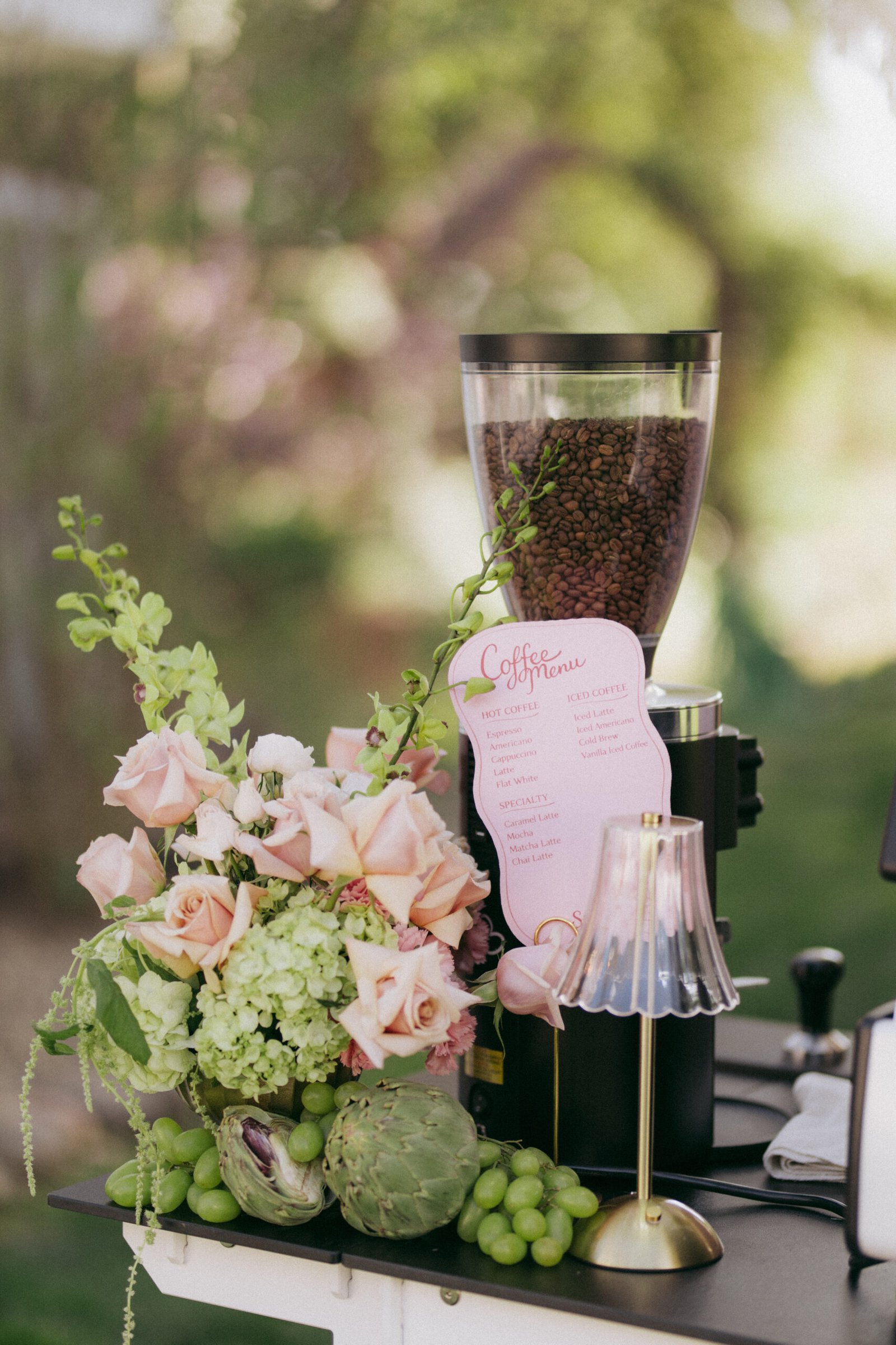 Grinder, roses and coffee menu on the cart