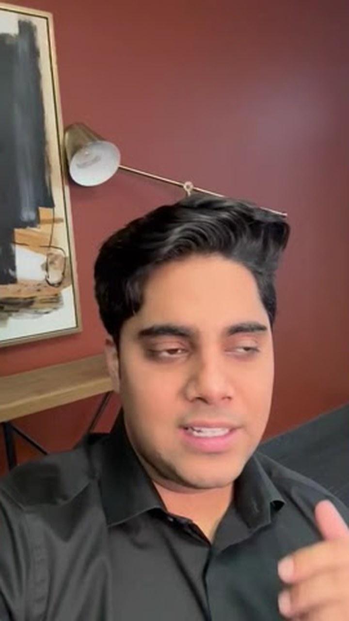 Saad from SMMP talking to camera in a room with a red wall