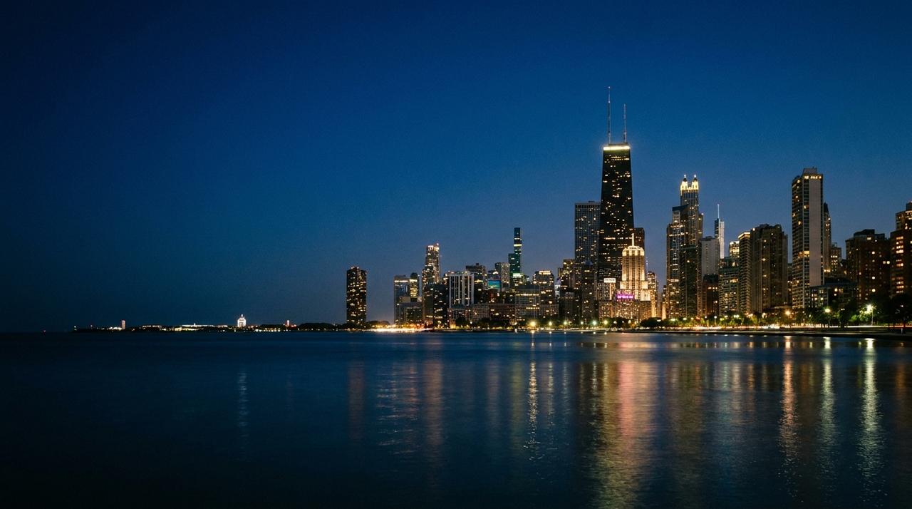 The Chicago skyline at blue hour seen across Lake Michigan, with the Gold Coast lit up along the lakefront