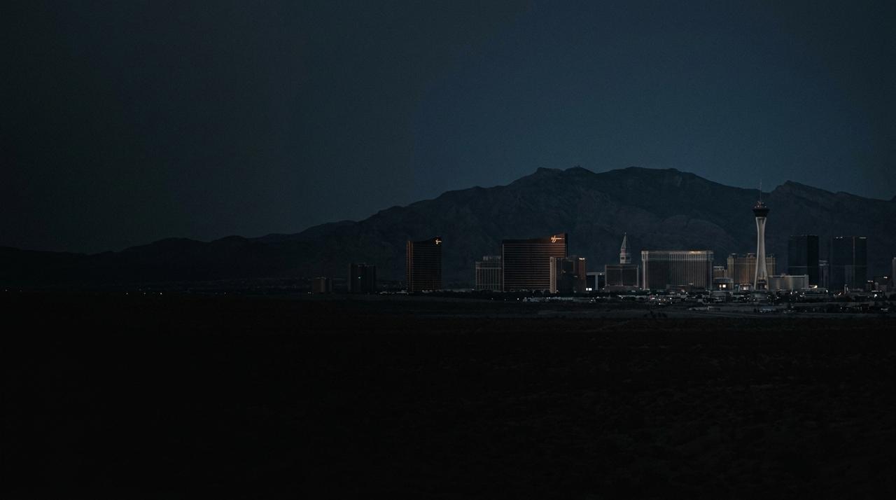 The Las Vegas Strip skyline at dusk with the mountains behind
