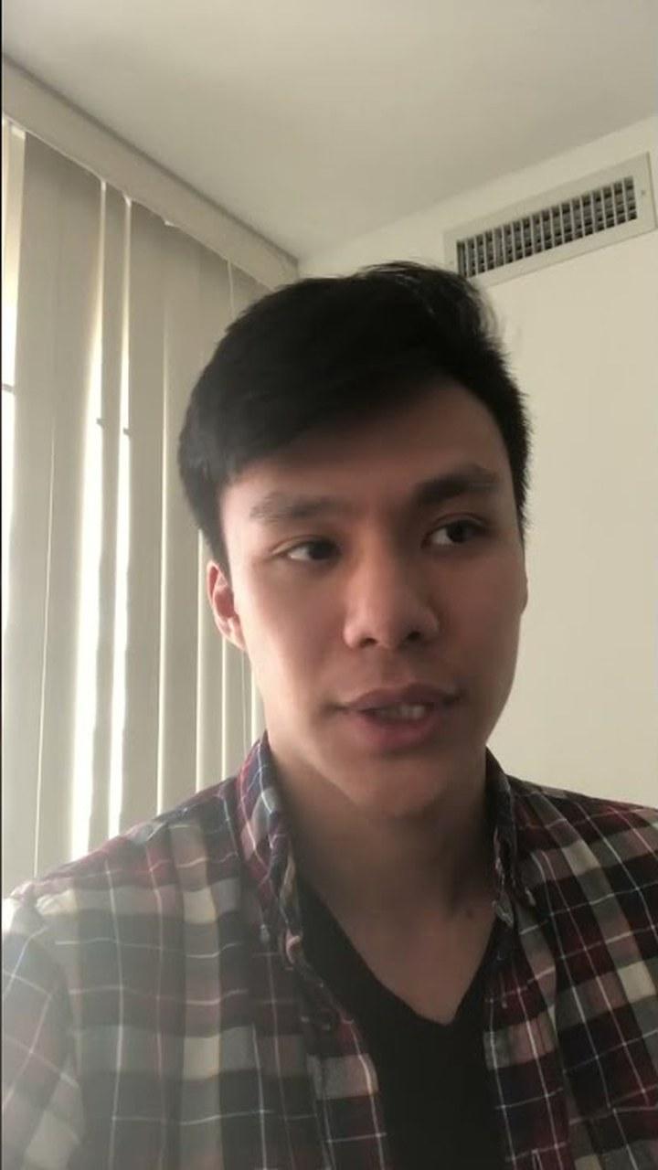 A client in a plaid shirt talking to camera in a bright room