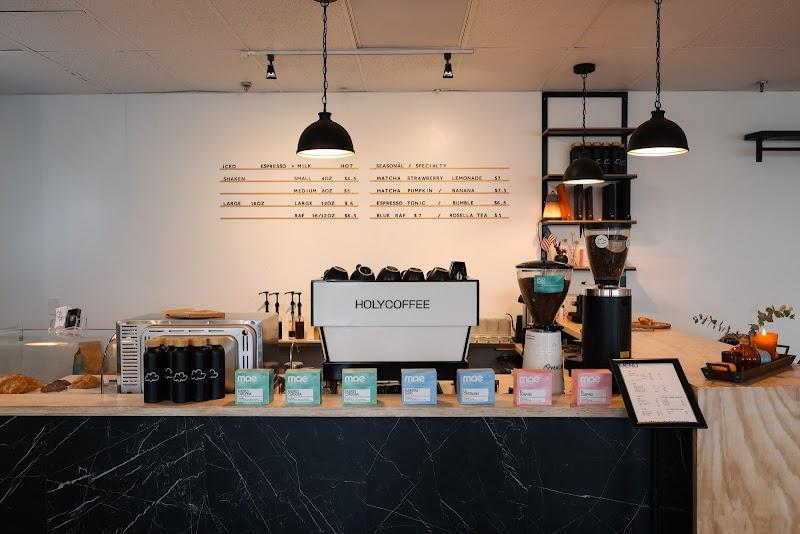 The menu board inside the Holy Coffee shop