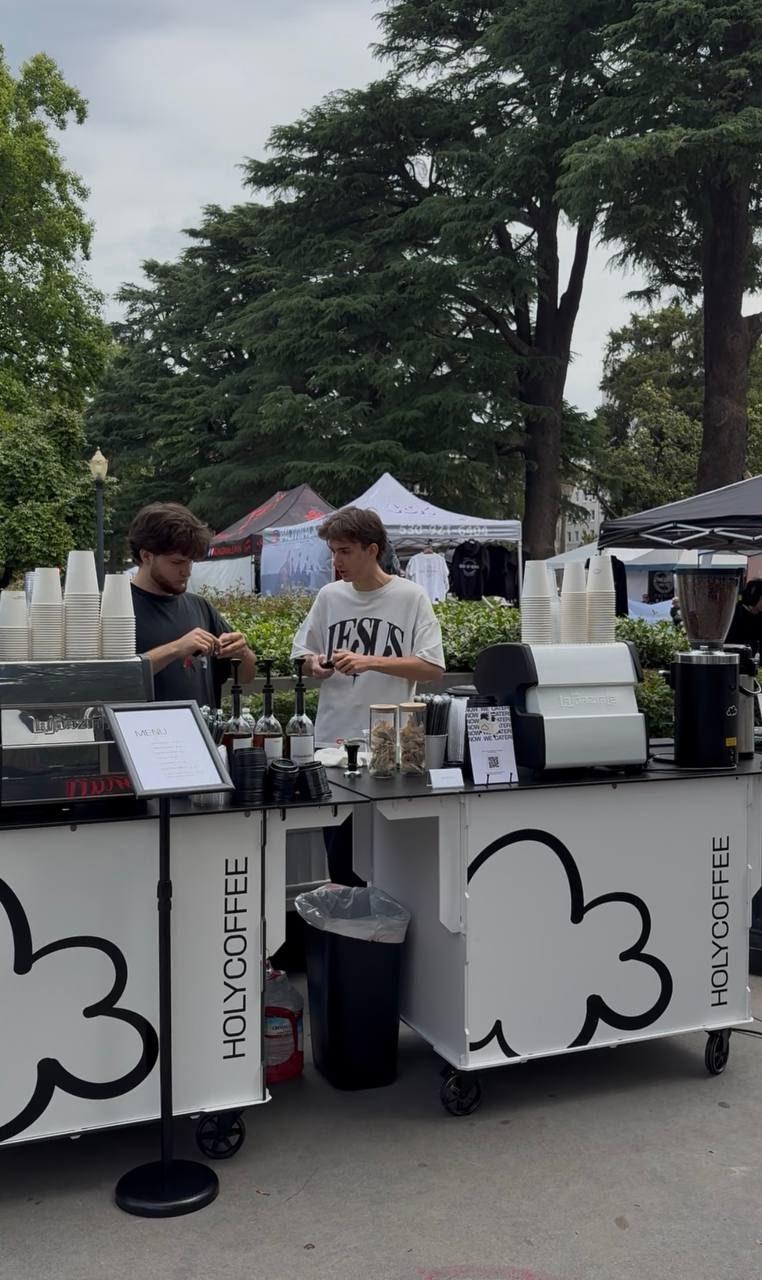 Two Holy Coffee carts serving side by side at an outdoor festival