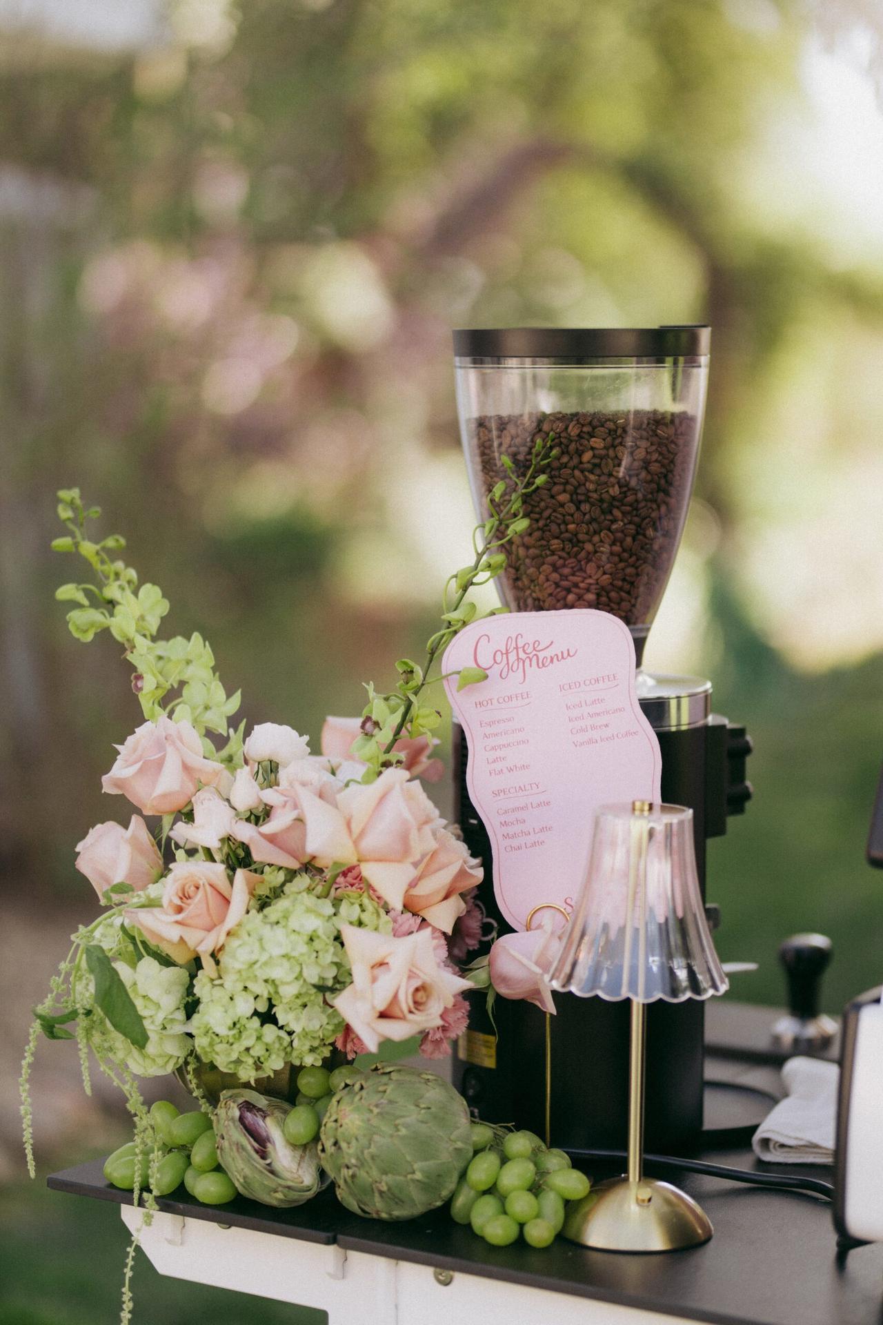 Grinder, roses and coffee menu on the cart