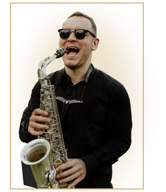 Igor Pererodov playing alto saxophone, smiling, in a black shirt