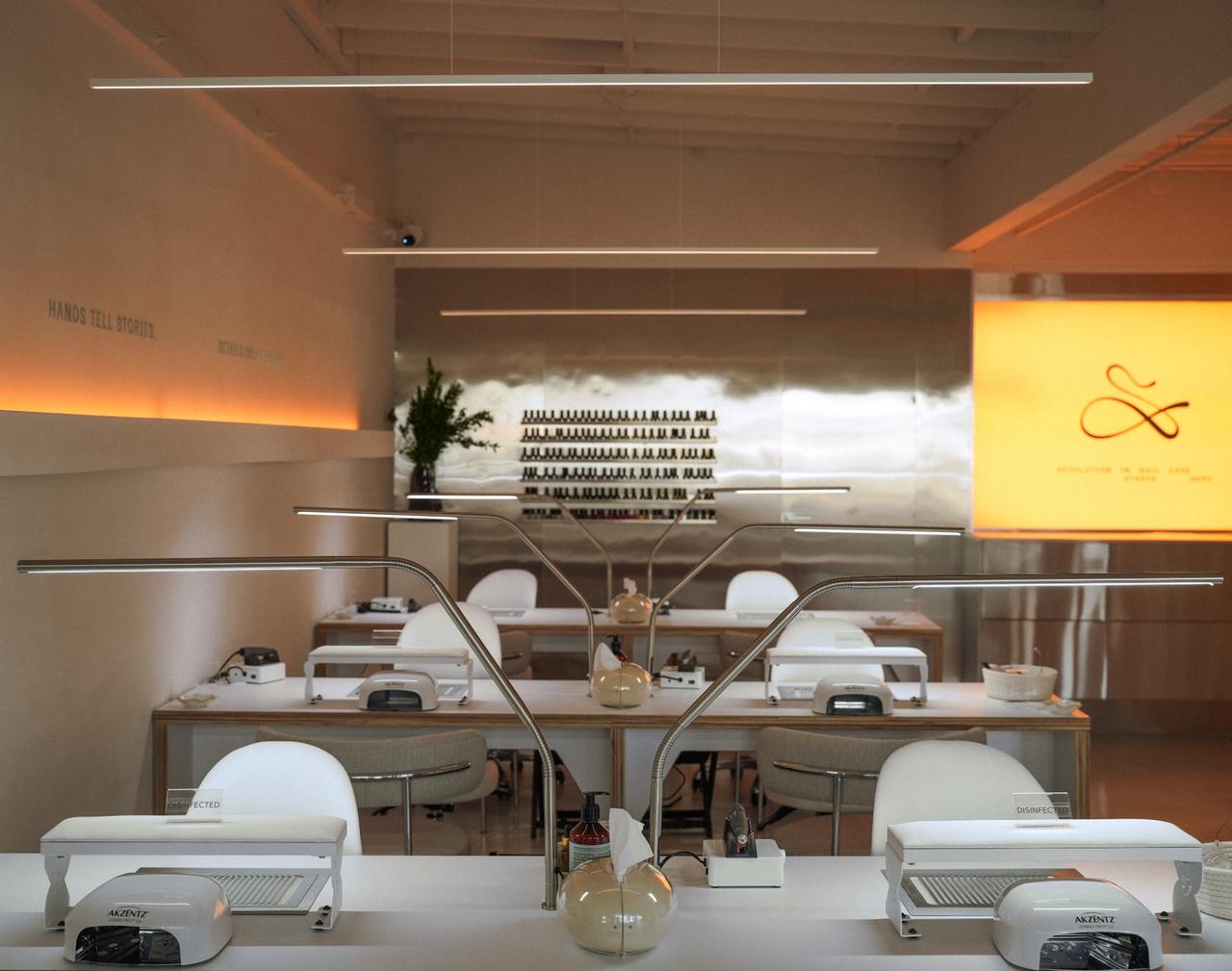 Manicure stations at Svitnail with extraction tables and lamps